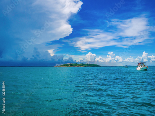 Amazing Idyllic ocean and Cloudy sky with fishmer boat in vacation time