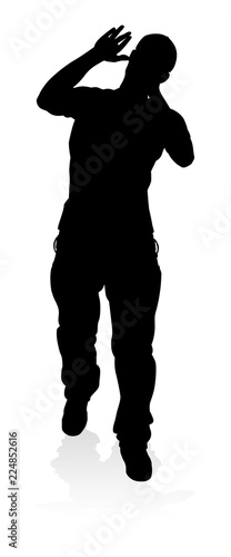 A singer pop, country music, rock star or hiphop rapper artist vocalist singing in silhouette
