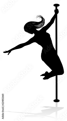 A woman pole dancer exercising for fitness in silhouette