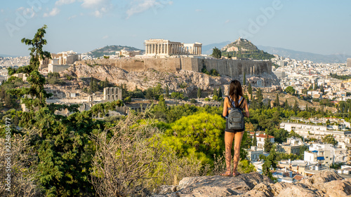 Teen standing on hill in facing the Acropolis photo