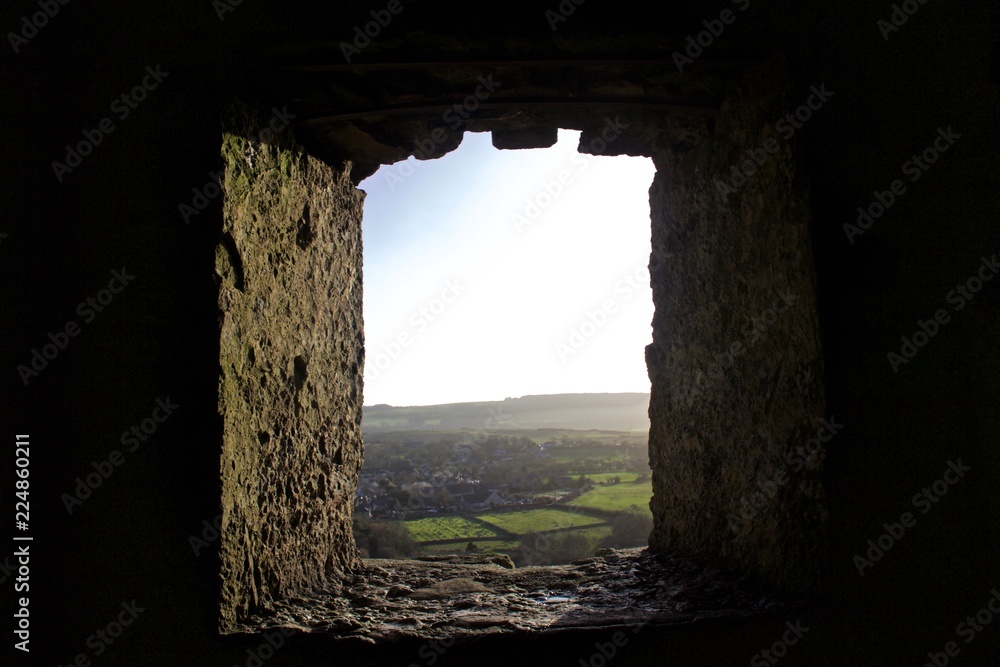 View From Stone Castle Window of Small English Country Town at Sunset
