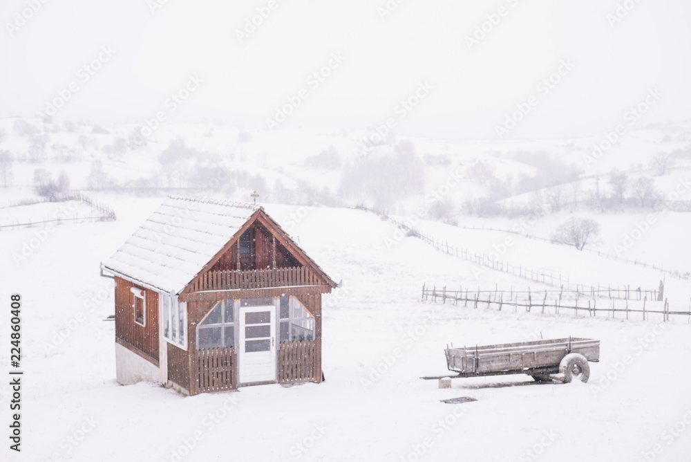 Lonely cabin in snow landscape.