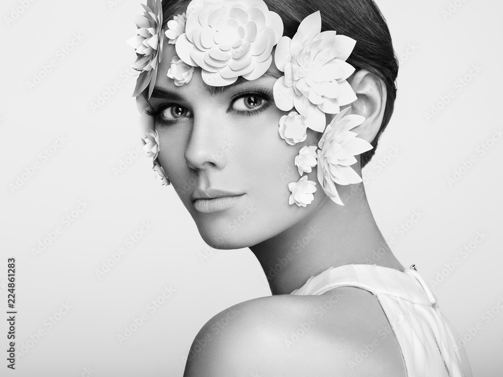 Face of Beautiful Woman Decorated with Flowers. Perfect Makeup. Beauty Fashion Model Woman Face perfect Skin. Paper Flowers