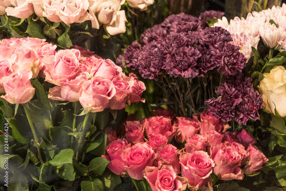 beautiful pink and burgundy roses and carnation flowers at flower shop
