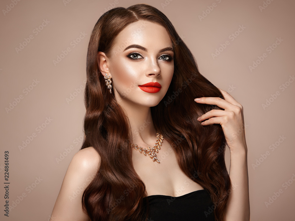 Brunette Girl with Long Healthy and Shiny Curly Hair. Care and Beauty. Beautiful Model Woman with Wavy Hairstyle. Make-Up and Jewelry Brunette Girl with Long Healthy and Shiny Curly Hair. Care and Beauty. Beautiful Model Woman with Wavy Hairstyle. Make-Up and Jewelry