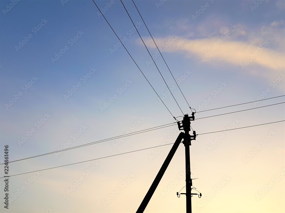 electric pole with twilight blue sky and white clouds