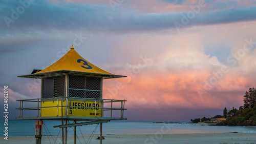 Colourful sky over lifeguard tower on beach © jmimages