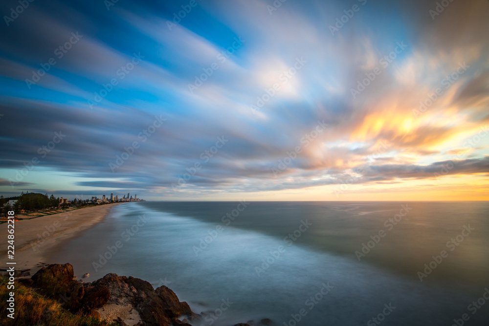 Long exposure of sunrise over ocean and beach Long exposure of sunrise over ocean and beach
