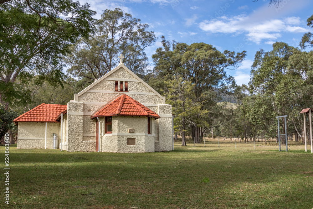 Country stone church in rural landscape setting