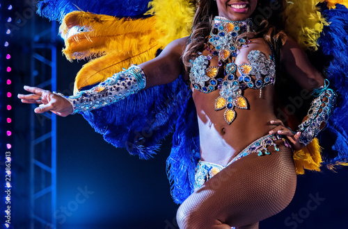 Vászonkép Beautiful bright colorful carnival costume dark background
