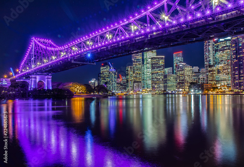 Illuminated bridge above river in night