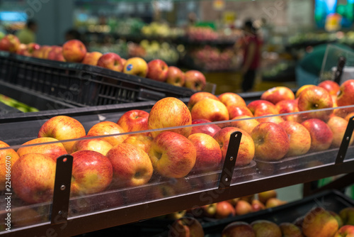 Fresh healthy fruits on shelves in supermarket