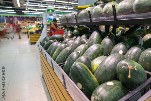 Fresh healthy fruits on shelves in supermarket