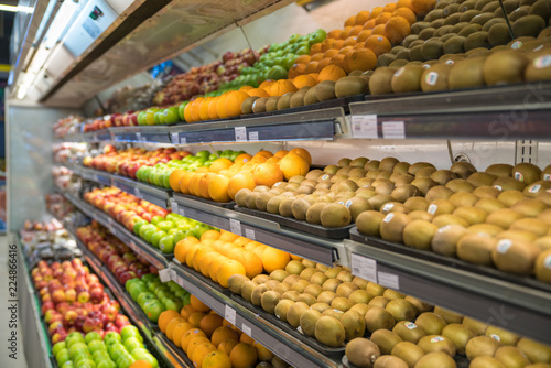 Fresh healthy fruits on shelves in supermarket