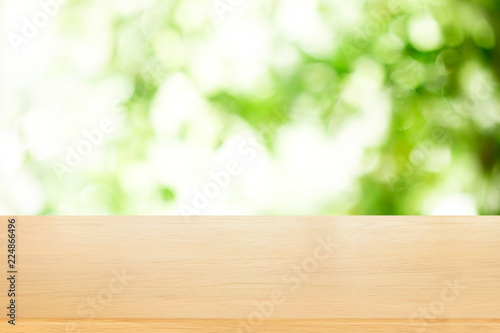 wooden plank table top with blur park green nature background bokeh light , for display or montage of product,Spring and Summer concept.
