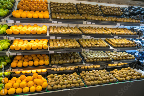 Fresh healthy fruits on shelves in supermarket