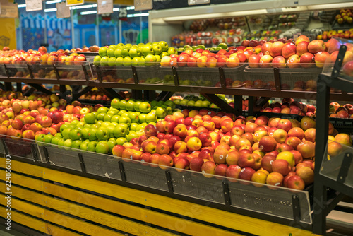 Fresh healthy fruits on shelves in supermarket