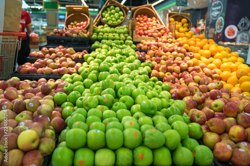 Fresh healthy fruits on shelves in supermarket