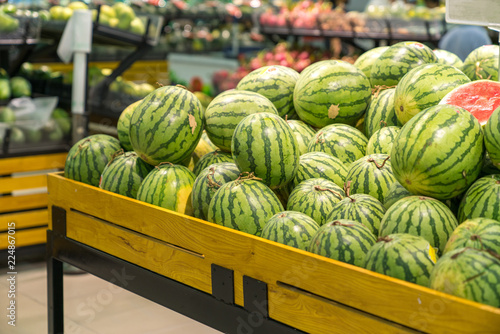 Fresh healthy fruits on shelves in supermarket