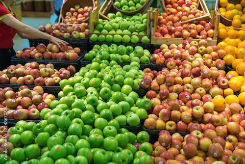 Fresh healthy fruits on shelves in supermarket