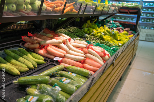 Fresh tropical vegetable on shelves in modern supermarket