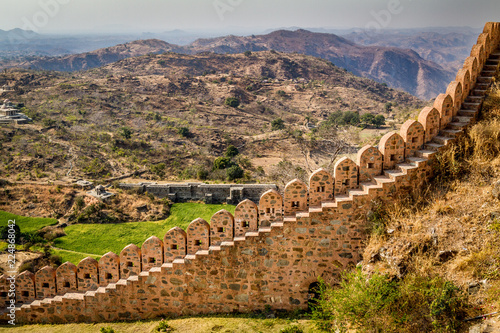 Stepped stone wall with hills in background Kumbhalgarh Fort Rajasthan photo
