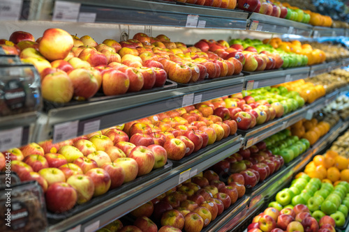 Fresh healthy fruits on shelves in supermarket