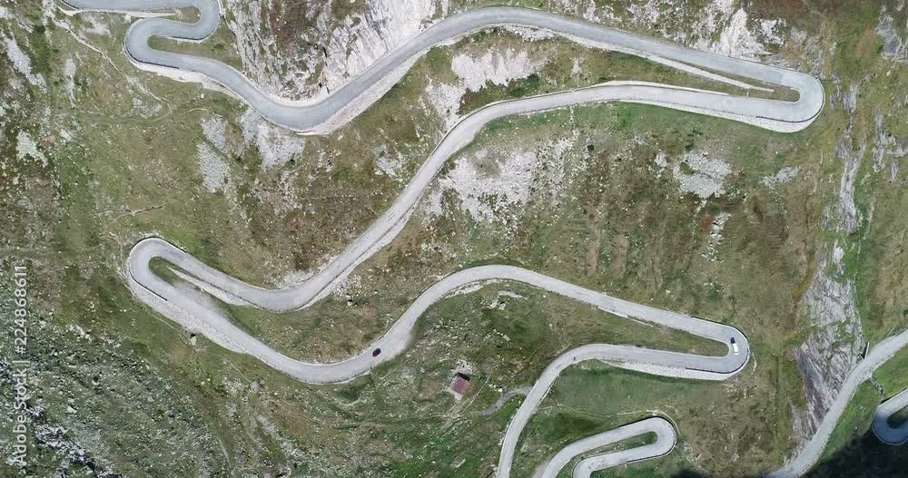 Aerial view of the Gotthard Pass road with many curves and serpentines on the Ticino side in the direction of Airolo, Switzerland. The street is called Tremola Aerial view of the Gotthard Pass road with many curves and serpentines on the Ticino side in the direction of Airolo, Switzerland. The street is called Tremola