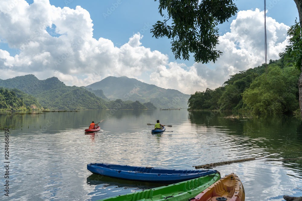 Landscape in Hoa Binh province, Vietnam, with people kayaking on the river