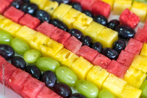 Chopped fresh raw colorful fruits arranged on dish