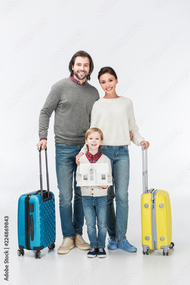 smiling boy holding carton house ready to move with his family into new house isolated on white smiling boy holding carton house ready to move with his family into new house isolated on white