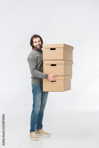man holding stack of cardboard boxes isolated on white
