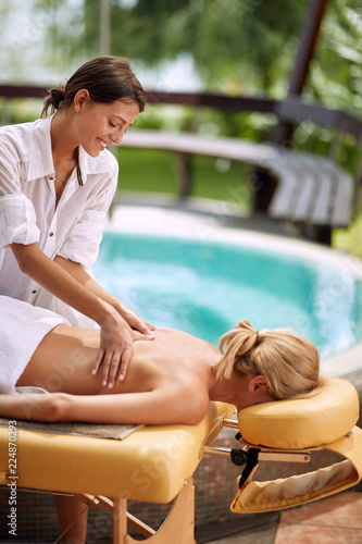 woman at spa and wellness back massage treatment.