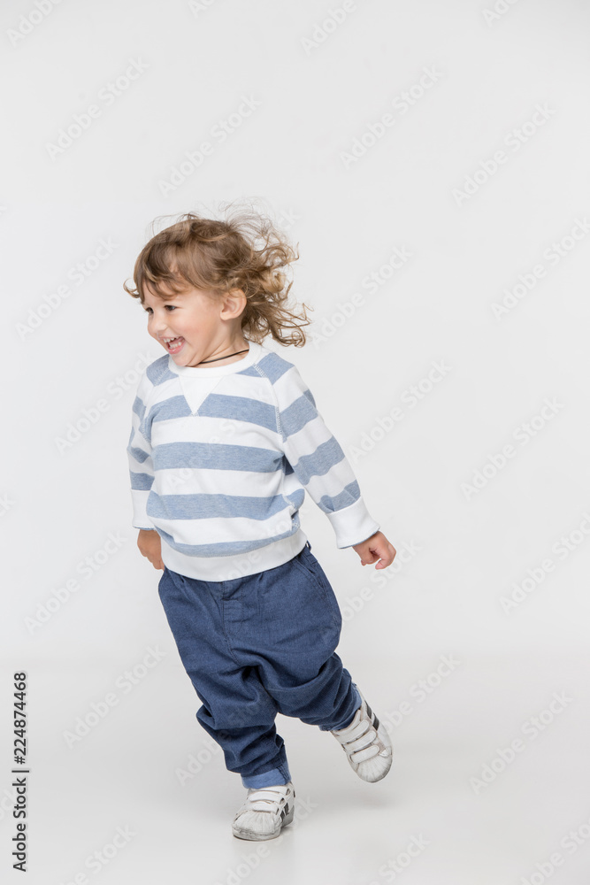 Portrait of happy joyful running beautiful little boy, studio shot on white Portrait of happy joyful running beautiful little boy, studio shot on white