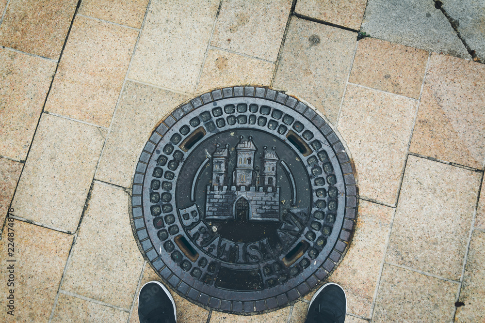 view of manhole cover in old town Bratislava, Slovakia view of manhole cover in old town Bratislava, Slovakia