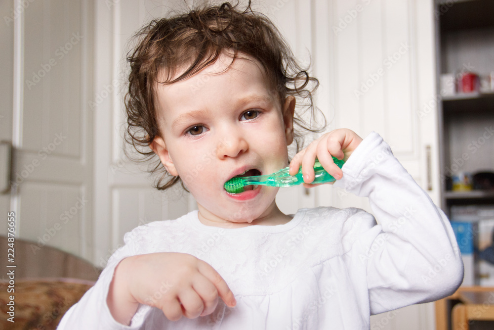 baby child brush their teeth properly with a green toothbrush baby child brush their teeth properly with a green toothbrush