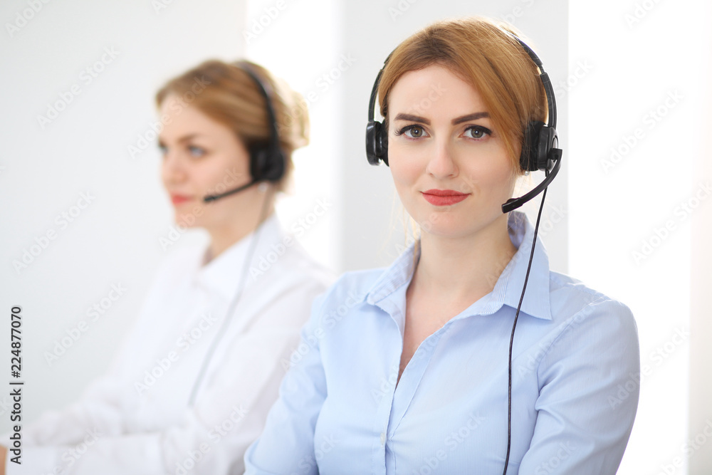 Call center. Focus on beautiful woman in headset Call center. Focus on beautiful woman in headset