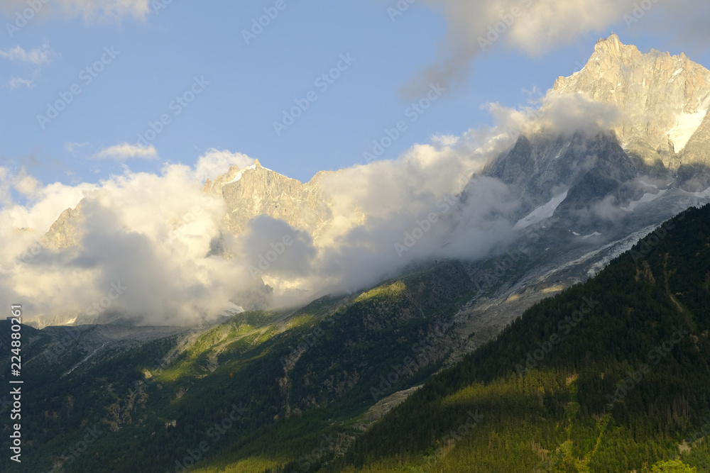 Alpine landscape under the clouds and valley at sunset, Mont Blanc, France.