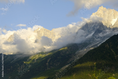 Alpine landscape under the clouds and valley at sunset, Mont Blanc, France.