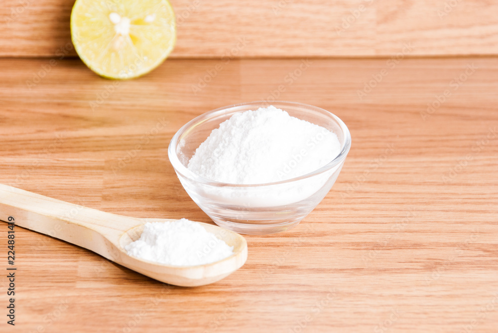 baking soda and lemon on wooden table baking soda and lemon on wooden table