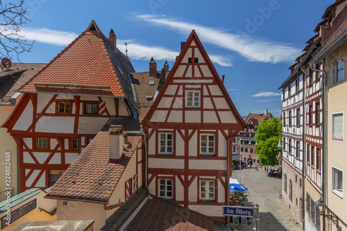 Facade of traditional German half-timbered house, old city and the square Tiergaertnertorplatz Nuremberg, Bavaria, Germany.