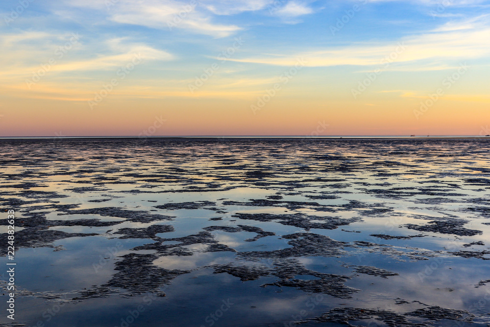 Fototapeta premium Sunrise over ocean mudflats at low tide