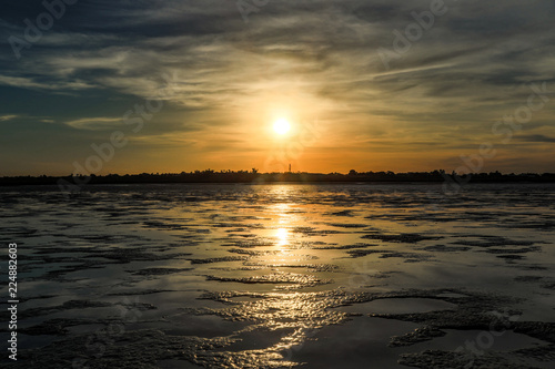 Sunrise over ocean mudflats at low tide