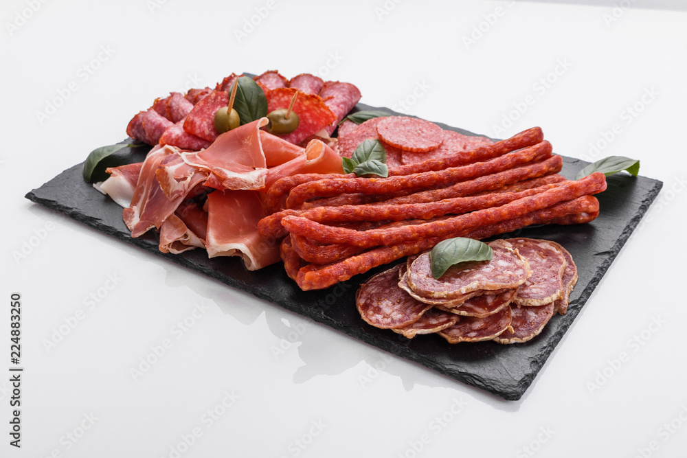 Cold smoked meat plate on a white background Cold smoked meat plate on a white background