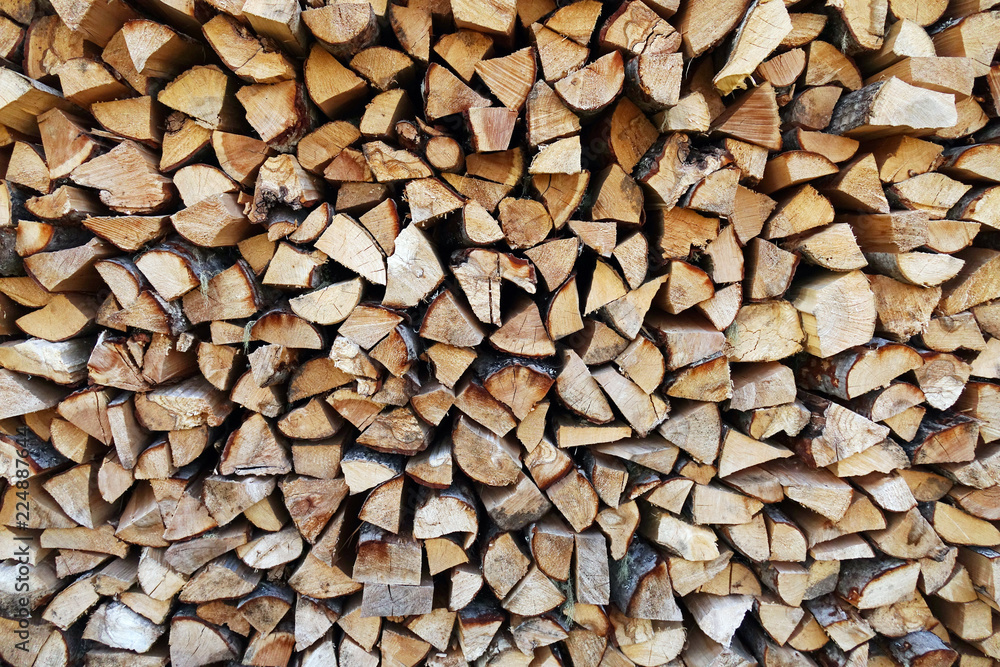 Chopped wood laid in a woodpile to dry for the winter. Wood texture. Chopped wood laid in a woodpile to dry for the winter. Wood texture.
