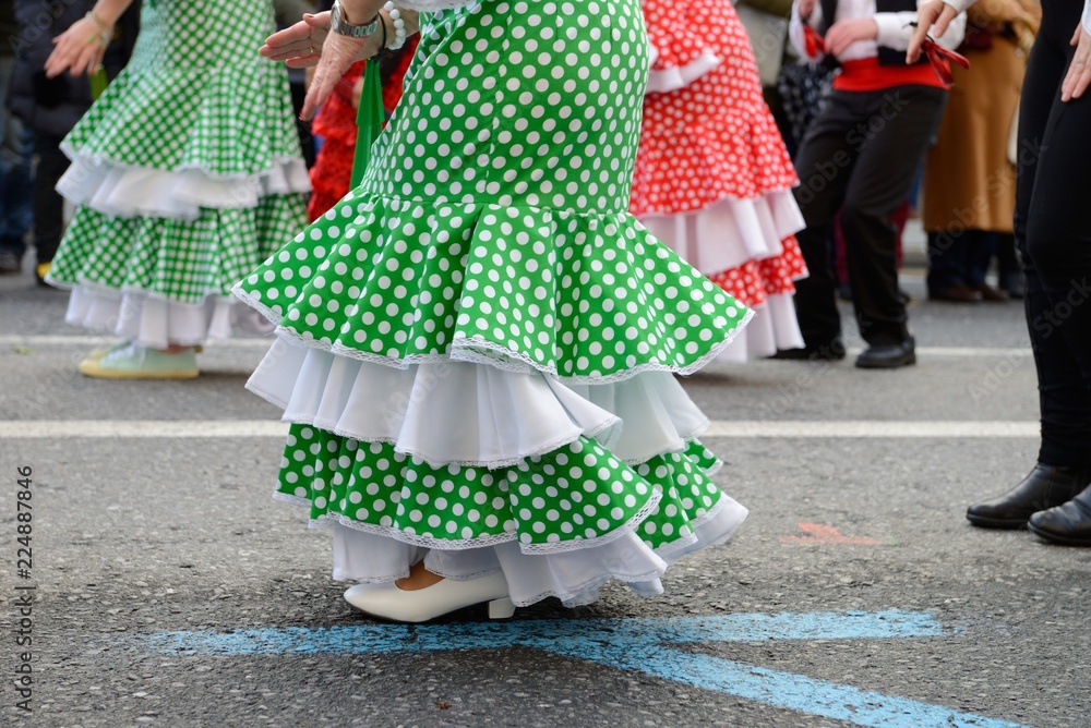people in Spanish carnival costumes on the street