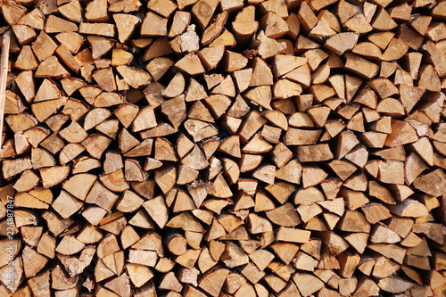 Chopped wood laid in a woodpile to dry for the winter. Wood texture.