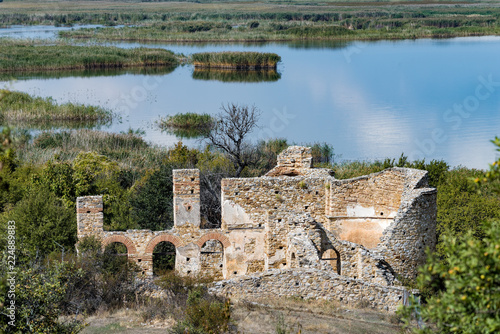 Landscape with the ruins of the Basilica of Agios (Saint) Achillios at the Small Prespa Lake in northern Greece photo