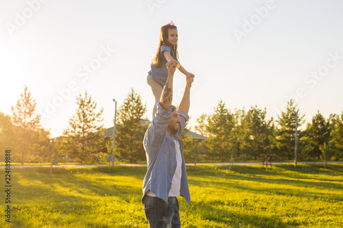 Fatherhood, family and children concept - Father and daughter having fun and playing in nature.