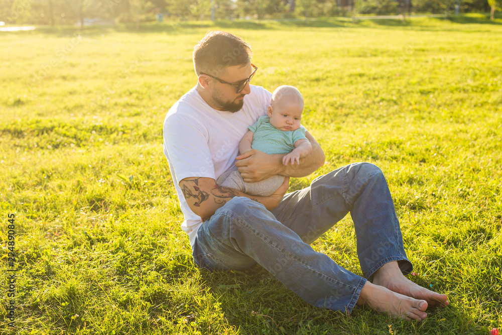 Happy father holding baby son on nature. Concept of happy family, father's day and child. Happy father holding baby son on nature. Concept of happy family, father's day and child.